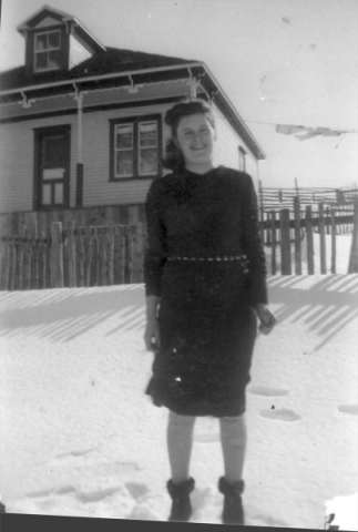 479: Sadie Norman at Margarees Cove, her brother Gar's house in the background. (circa 1940)  [courtesy of Della (Norman) O'Leary]  - Daughter of Thomas Norman &amp;amp; Jane Traverse, married Leo Kerrivan